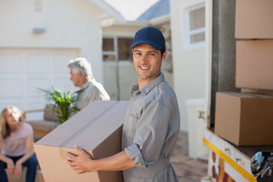 Man in a blue cap moving boxes