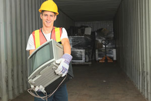 Worker in safety gear carrying monitor