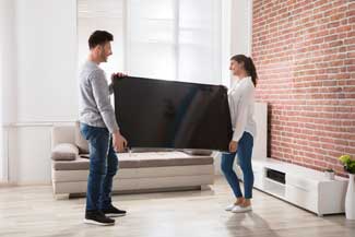 couple moving a tv